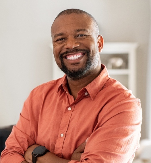 Man with healthy smile after dental crown restoration