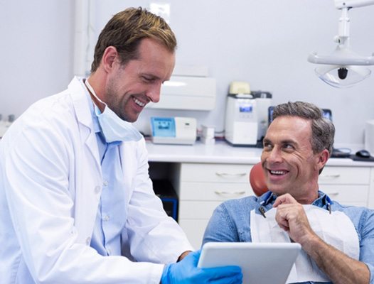 Man meeting with dentist about partial dentures in Phoenix
