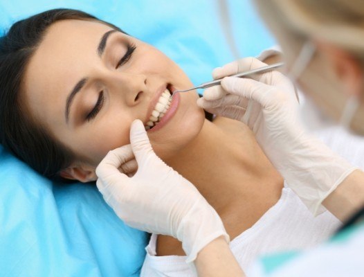 Dentist examining patient's smile to provide diagnosis and periodontal treatment planning